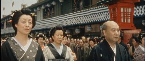 In the procession, the middle-age woman, Oken, is seen smiling, while the middle-aged man, Hyogoya, has an anxious look on his face