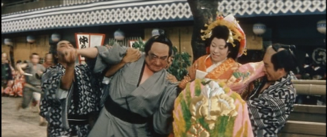 Jirō, the man with the sword, struggles in the street with the courtesan, Otsuru, while bodyguards attempt to separate them