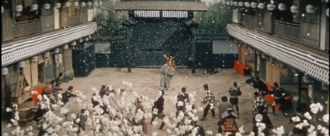 The man in the far background, surrounded by guards trying to capture or kill him, cries out as cherry blossoms fall