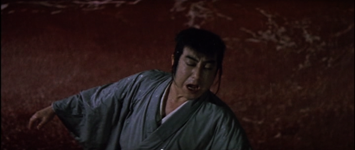 In ancient Japan, a blind man stumbles while in the background blood-red water surges