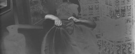 Quasi-negative image of the man in the previous image with his back to the camera, and the woman unseen except for the arms around the back of the man's neck