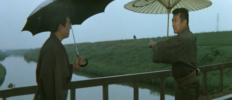 The same two men are seen in a two-shot on the bridge, with a rickshaw on the road in the far distance, to which one of the men points