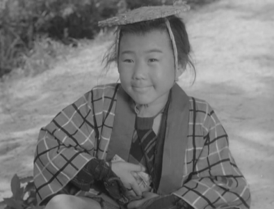 The feudal horse boy Sankichi, wearing a sedge cap and sitting on the ground, smiles up at the princess.