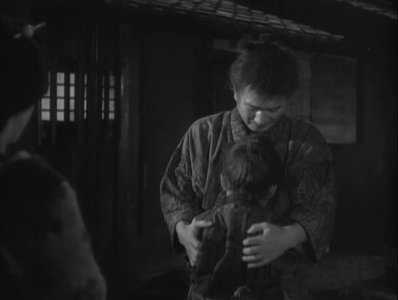 At night, the samurai is embraced by the distraught Horse Boy and the prostitute, on the left-hand of the photo's frame, watches them