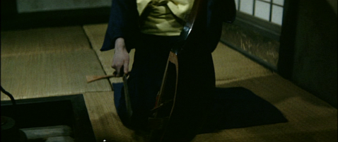 The Japanese woman, seen from the waist down, is holding the biwa, the front of which has been broken open; she carries a knife in her right hand