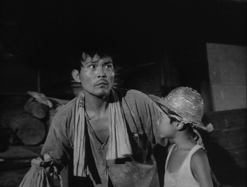 A Japanese man and boy at night, both wearing the clothes of poor people, look around them apprehensively in the midst of a wasteland 